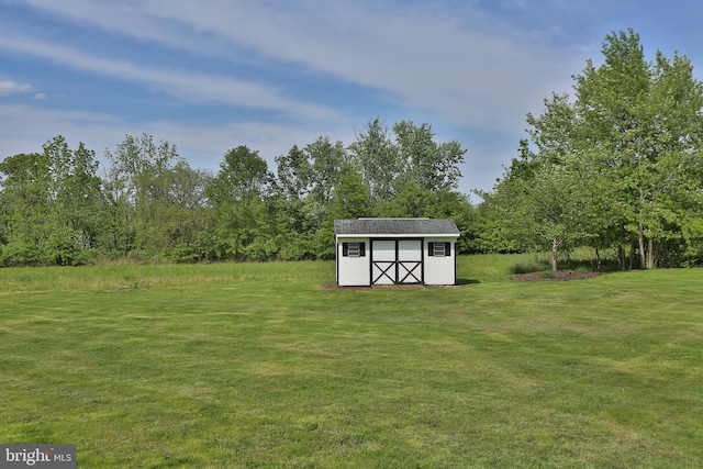 view of green lawn with a shed and an outdoor structure