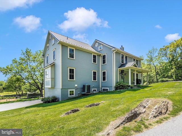 15953 River Bend Ct, Williamsport, MD 21795 - rear view of property with a porch, a standing seam roof, a lawn, a metal roof, and a chimney