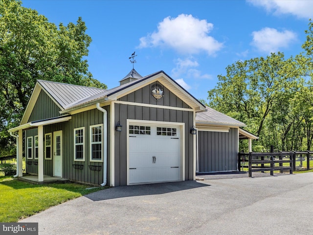 15953 River Bend Ct, Williamsport, MD 21795 - view of front of home with board and batten siding, a garage, driveway, and a metal roof
