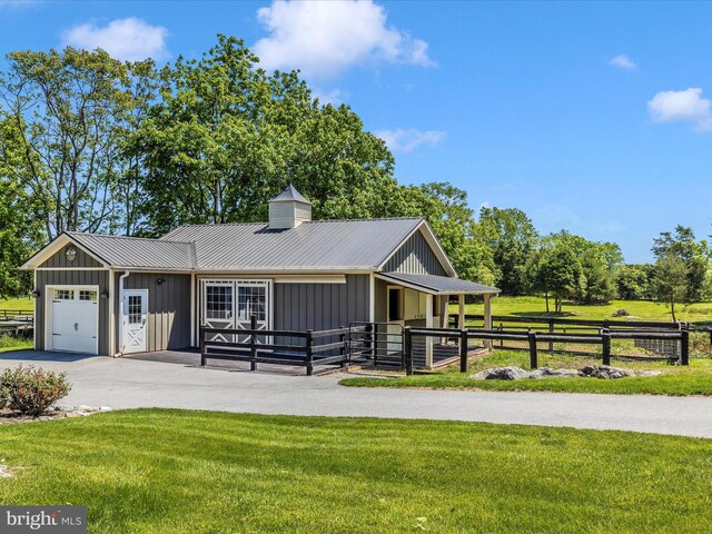 15953 River Bend Ct, Williamsport, MD 21795 - view of front of home with board and batten siding, an attached garage, an exterior structure, a metal roof, and an outbuilding