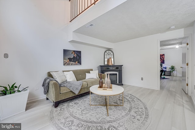 13916 Preacher Chapman Pl, Centreville, VA 20121 - living room featuring light wood-style floors, baseboards, and a textured ceiling