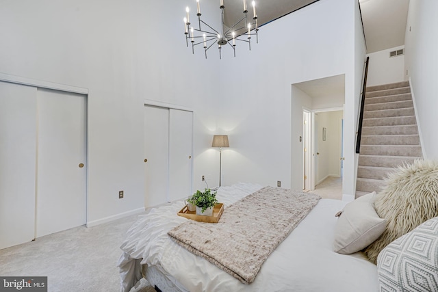 13916 Preacher Chapman Pl, Centreville, VA 20121 - bedroom featuring light carpet, multiple closets, a towering ceiling, a chandelier, and baseboards