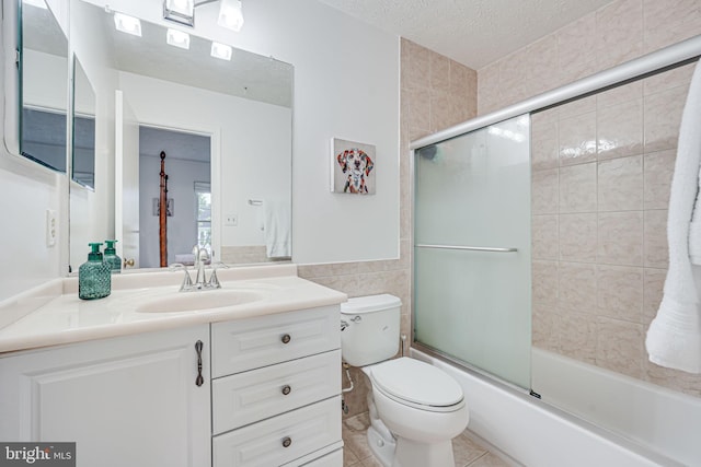13916 Preacher Chapman Pl, Centreville, VA 20121 - full bathroom featuring tile walls, toilet, vanity, combined bath / shower with glass door, and a textured ceiling