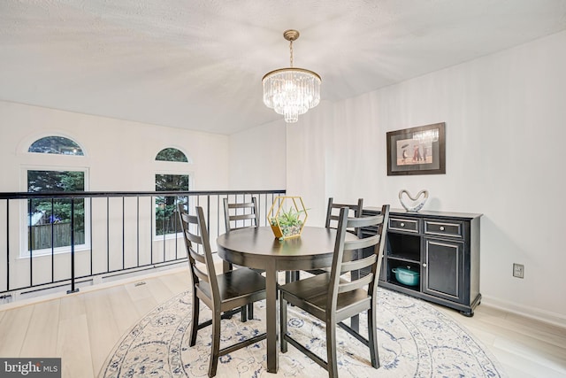 13916 Preacher Chapman Pl, Centreville, VA 20121 - dining space featuring a chandelier, light wood-type flooring, and baseboards