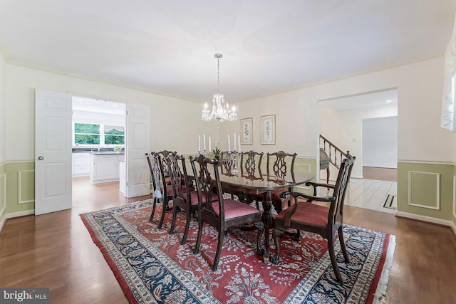 6808 Canal Bridge Ct, Potomac, MD 20854 - dining area with a chandelier, a wainscoted wall, wood finished floors, and ornamental molding