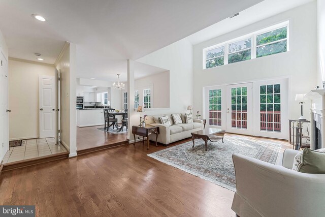 6808 Canal Bridge Ct, Potomac, MD 20854 - living area featuring a chandelier, wood finished floors, a fireplace, recessed lighting, and a towering ceiling