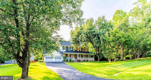 6808 Canal Bridge Ct, Potomac, MD 20854 - view of front of property featuring a porch, asphalt driveway, a front yard, and a garage