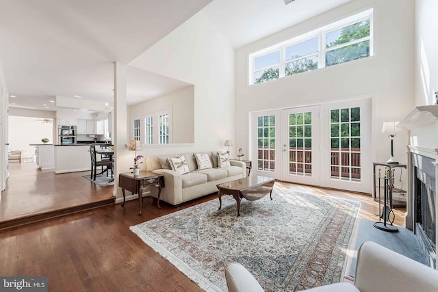 6808 Canal Bridge Ct, Potomac, MD 20854 - living room featuring a fireplace, wood finished floors, a high ceiling, and french doors