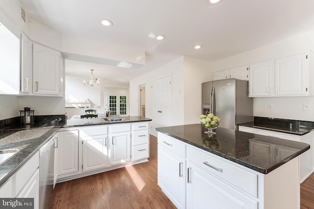6808 Canal Bridge Ct, Potomac, MD 20854 - kitchen with appliances with stainless steel finishes, a chandelier, light wood-style floors, white cabinetry, and dark stone counters