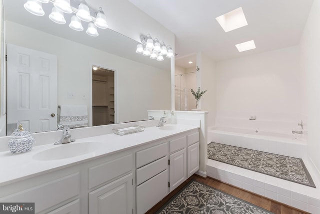 6808 Canal Bridge Ct, Potomac, MD 20854 - full bath featuring a skylight, double vanity, a bath, and wood finished floors