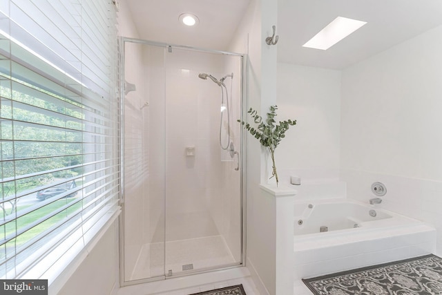 6808 Canal Bridge Ct, Potomac, MD 20854 - bathroom with a skylight, a shower stall, and a jetted tub