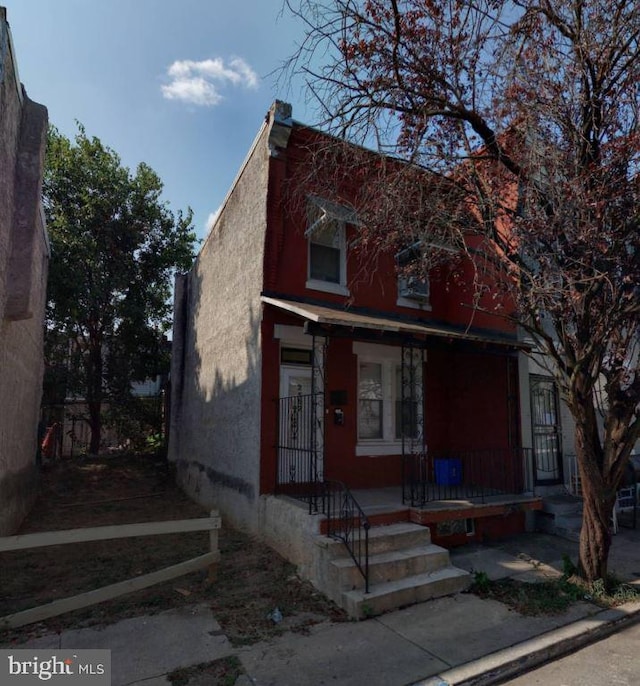 view of front of property with covered porch and stucco siding