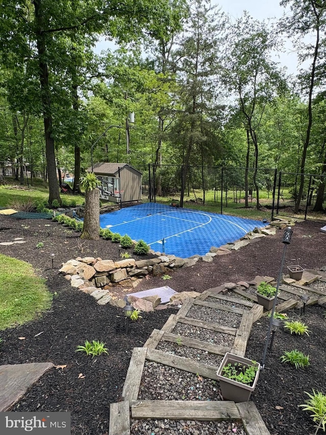 1715 Mountain View Rd, Harrisburg, PA 17110 - view of swimming pool with an outbuilding, view of wooded area, and basketball hoop