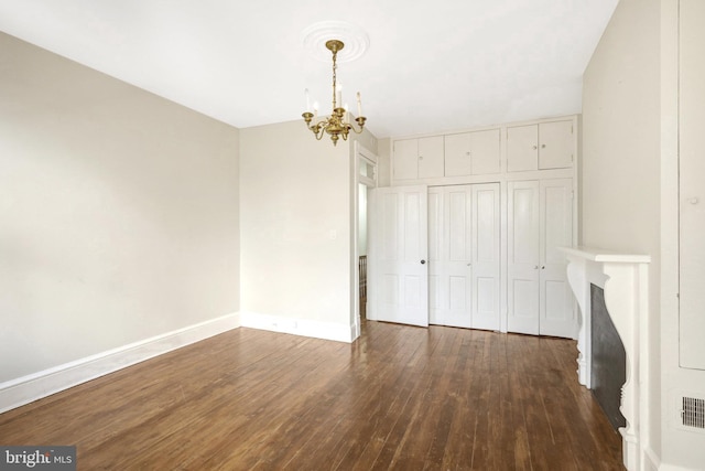 812 E St SE, Washington, DC 20003 - unfurnished dining area featuring a chandelier, dark wood-style flooring, and baseboards