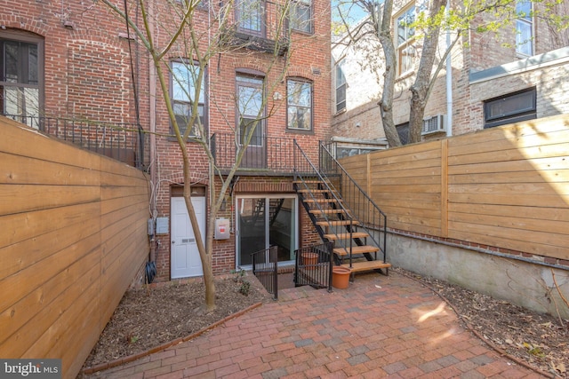 812 E St SE, Washington, DC 20003 - rear view of property featuring brick siding, stairway, and fence