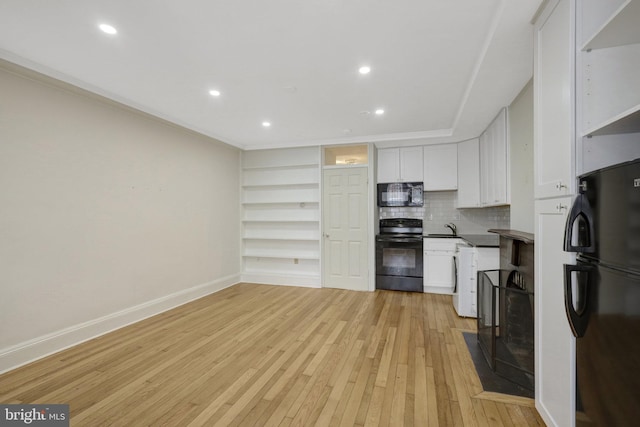 812 E St SE, Washington, DC 20003 - kitchen featuring black appliances, open shelves, light wood-style flooring, a sink, and white cabinetry