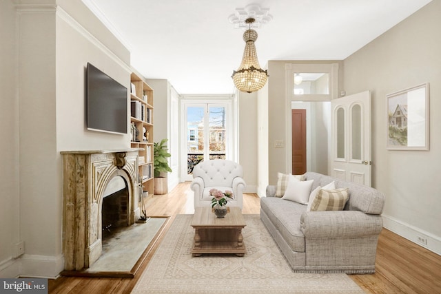 812 E St SE, Washington, DC 20003 - living room with wood finished floors, a chandelier, baseboards, and a premium fireplace