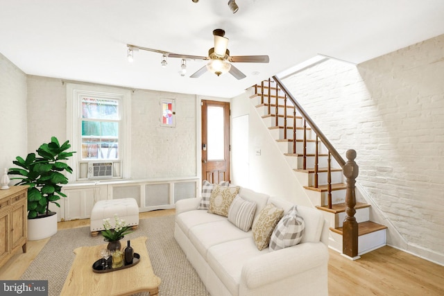 812 E St SE, Washington, DC 20003 - living area featuring rail lighting, light wood-style floors, a ceiling fan, brick wall, and stairway