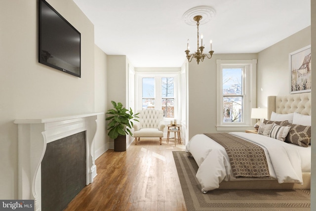 812 E St SE, Washington, DC 20003 - bedroom with hardwood / wood-style flooring, a chandelier, and baseboards