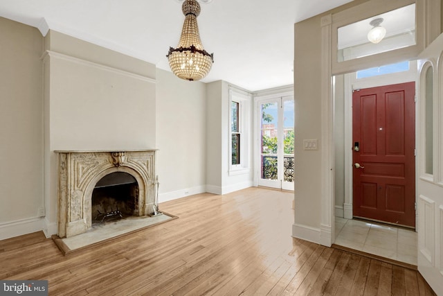 812 E St SE, Washington, DC 20003 - foyer entrance featuring hardwood / wood-style floors, a chandelier, baseboards, and a premium fireplace