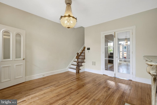 812 E St SE, Washington, DC 20003 - spare room featuring a chandelier, stairs, hardwood / wood-style flooring, and baseboards