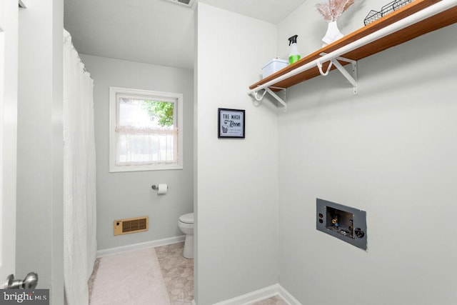 laundry room with hookup for a washing machine and baseboards