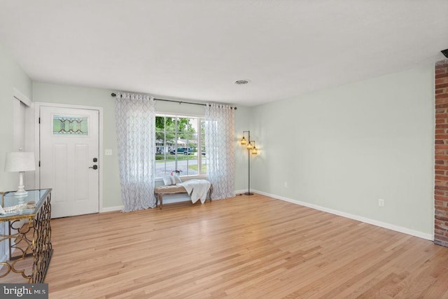 living room with light wood-style flooring and baseboards