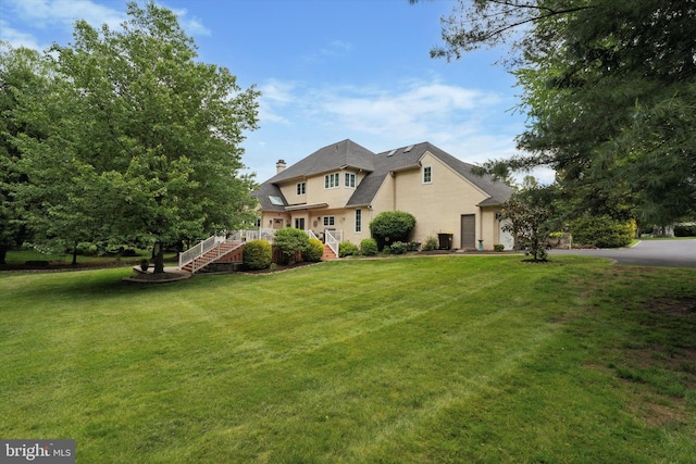 20 Dorchester Way, Phoenixville, PA 19460 - back of property featuring a yard, a chimney, and stucco siding