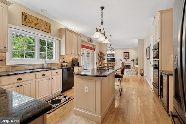 20 Dorchester Way, Phoenixville, PA 19460 - kitchen with a sink, black appliances, open floor plan, a center island, and light wood-style floors