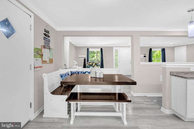 463 Bronco Trl, Lusby, MD 20657 - dining space featuring breakfast area, light wood-style flooring, crown molding, baseboards, and plenty of natural light
