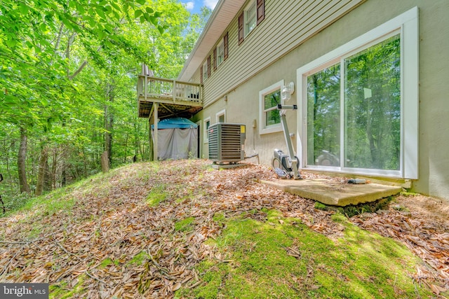 463 Bronco Trl, Lusby, MD 20657 - view of yard with central AC unit and a deck