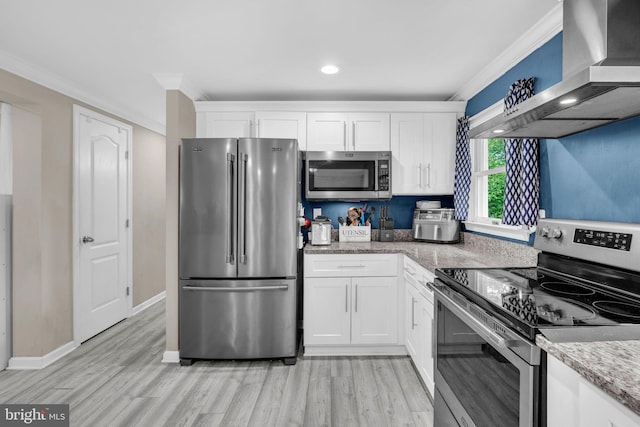 463 Bronco Trl, Lusby, MD 20657 - kitchen featuring appliances with stainless steel finishes, wall chimney exhaust hood, white cabinets, light wood-type flooring, and crown molding