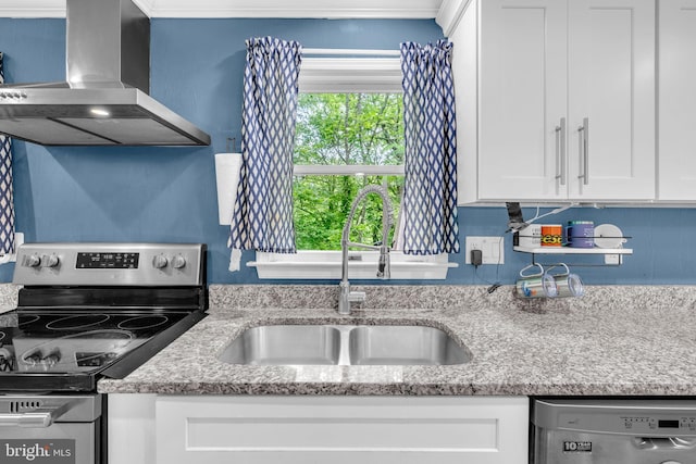 463 Bronco Trl, Lusby, MD 20657 - kitchen featuring appliances with stainless steel finishes, a sink, wall chimney exhaust hood, white cabinetry, and light stone counters