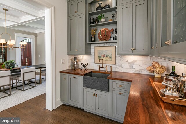 280 Carter Rd, Princeton, NJ 08540 - kitchen featuring butcher block countertops, a sink, a chandelier, ornamental molding, and decorative backsplash
