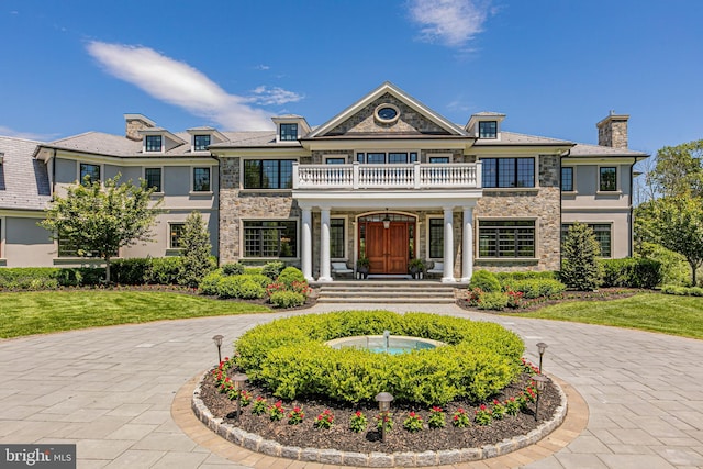 280 Carter Rd, Princeton, NJ 08540 - view of front facade with a balcony, stone siding, stucco siding, a chimney, and a front yard