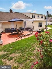 60 Windsor Ln, Willingboro, NJ 08046 - rear view of house featuring a patio and a chimney