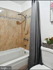 60 Windsor Ln, Willingboro, NJ 08046 - full bathroom featuring toilet and shower / bath combo with shower curtain