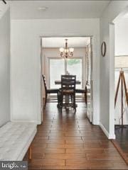 60 Windsor Ln, Willingboro, NJ 08046 - corridor with a chandelier, dark wood-style flooring, and baseboards