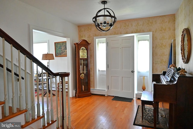 9706 Fairway Dr, New Market, VA 22844 - foyer with wallpapered walls, light wood-style floors, a chandelier, a baseboard heating unit, and stairway