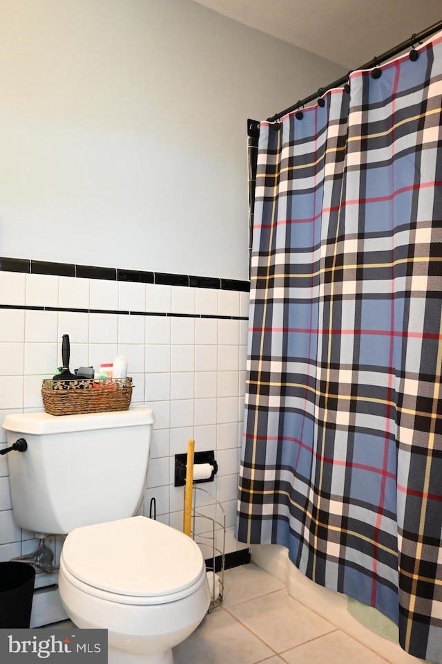 9706 Fairway Dr, New Market, VA 22844 - full bathroom featuring tile patterned flooring, tile walls, a shower with shower curtain, toilet, and wainscoting