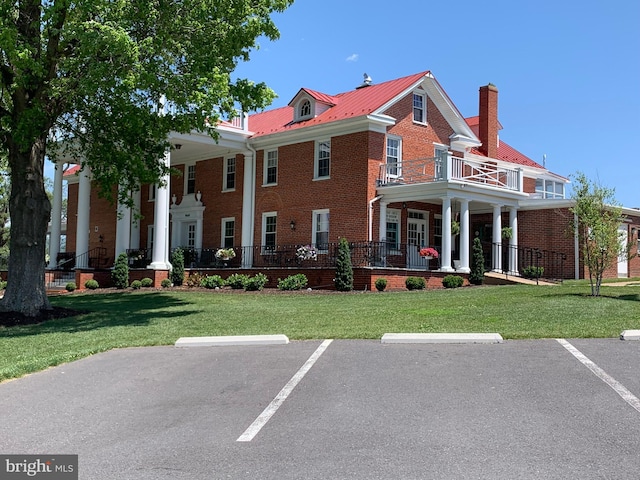 9706 Fairway Dr, New Market, VA 22844 - view of front of home with brick siding, uncovered parking, a balcony, and a front lawn