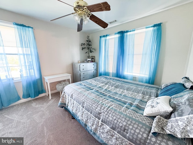 7226 Waldman Ave, Sparrows Point, MD 21219 - bedroom featuring multiple windows, carpet flooring, baseboards, and a ceiling fan