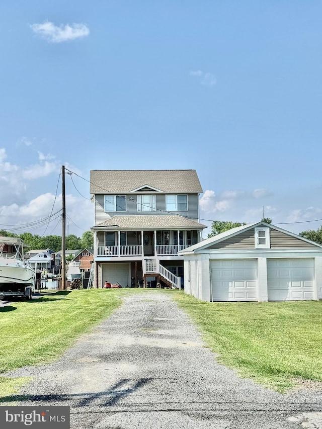 7226 Waldman Ave, Sparrows Point, MD 21219 - view of front of house with a garage, a front yard, covered porch, and driveway