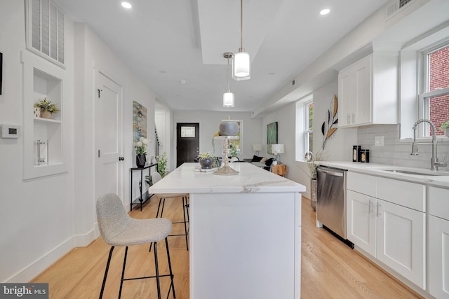 1636 40th St SE, Washington, DC 20020 - kitchen with a sink, dishwasher, a kitchen island, white cabinetry, and recessed lighting