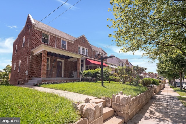 1636 40th St SE, Washington, DC 20020 - view of front of home featuring brick siding, a porch, and a front yard