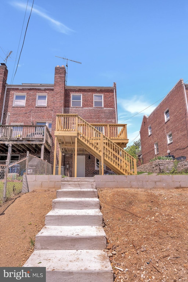 1636 40th St SE, Washington, DC 20020 - rear view of property featuring brick siding, stairway, and a wooden deck