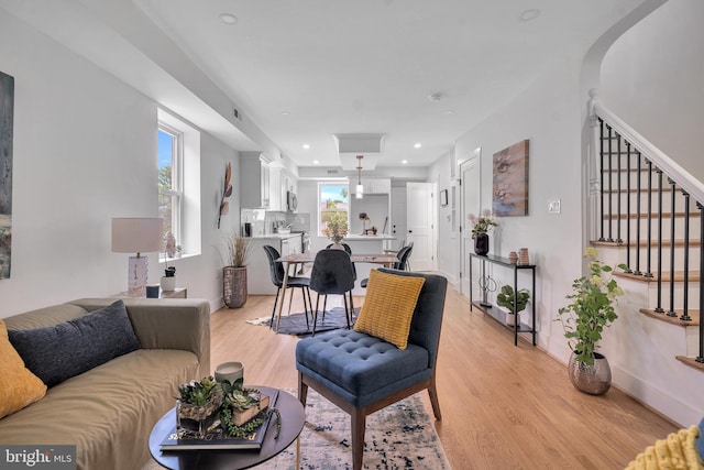 1636 40th St SE, Washington, DC 20020 - living room featuring light wood-style flooring, stairs, and recessed lighting