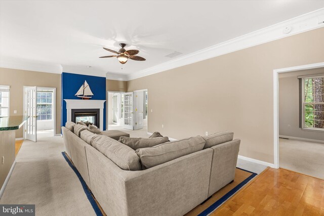11625 Manklin Creek Rd, Ocean Pines, MD 21811 - living area with ceiling fan, crown molding, light wood-style flooring, and a glass covered fireplace