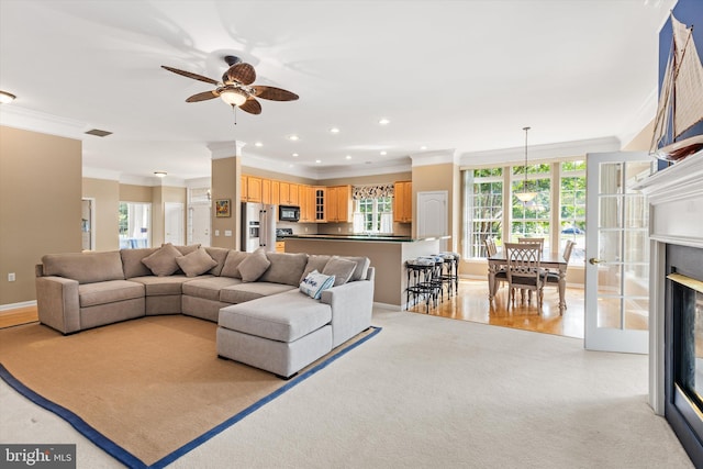 11625 Manklin Creek Rd, Ocean Pines, MD 21811 - living room with crown molding, ceiling fan, recessed lighting, light colored carpet, and a glass covered fireplace