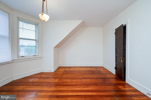bonus room featuring wood-type flooring and baseboards